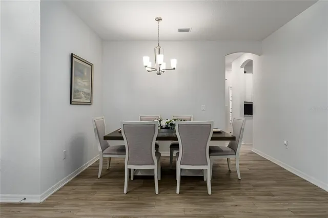 a view of a dining room with furniture and wooden floor