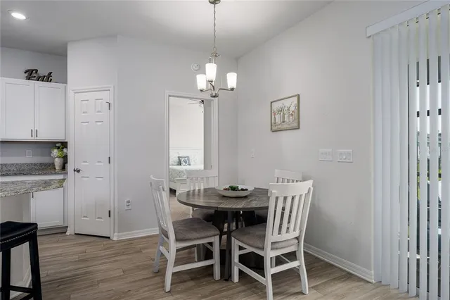 a view of a dining room with furniture wooden floor and a chandelier