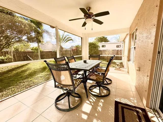 a view of a porch with furniture and a yard