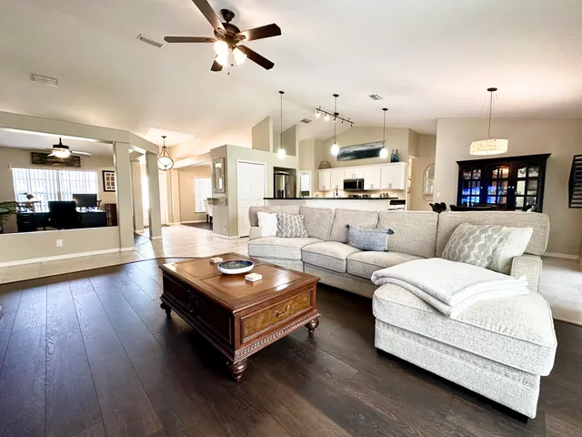a living room with furniture and a wooden floor