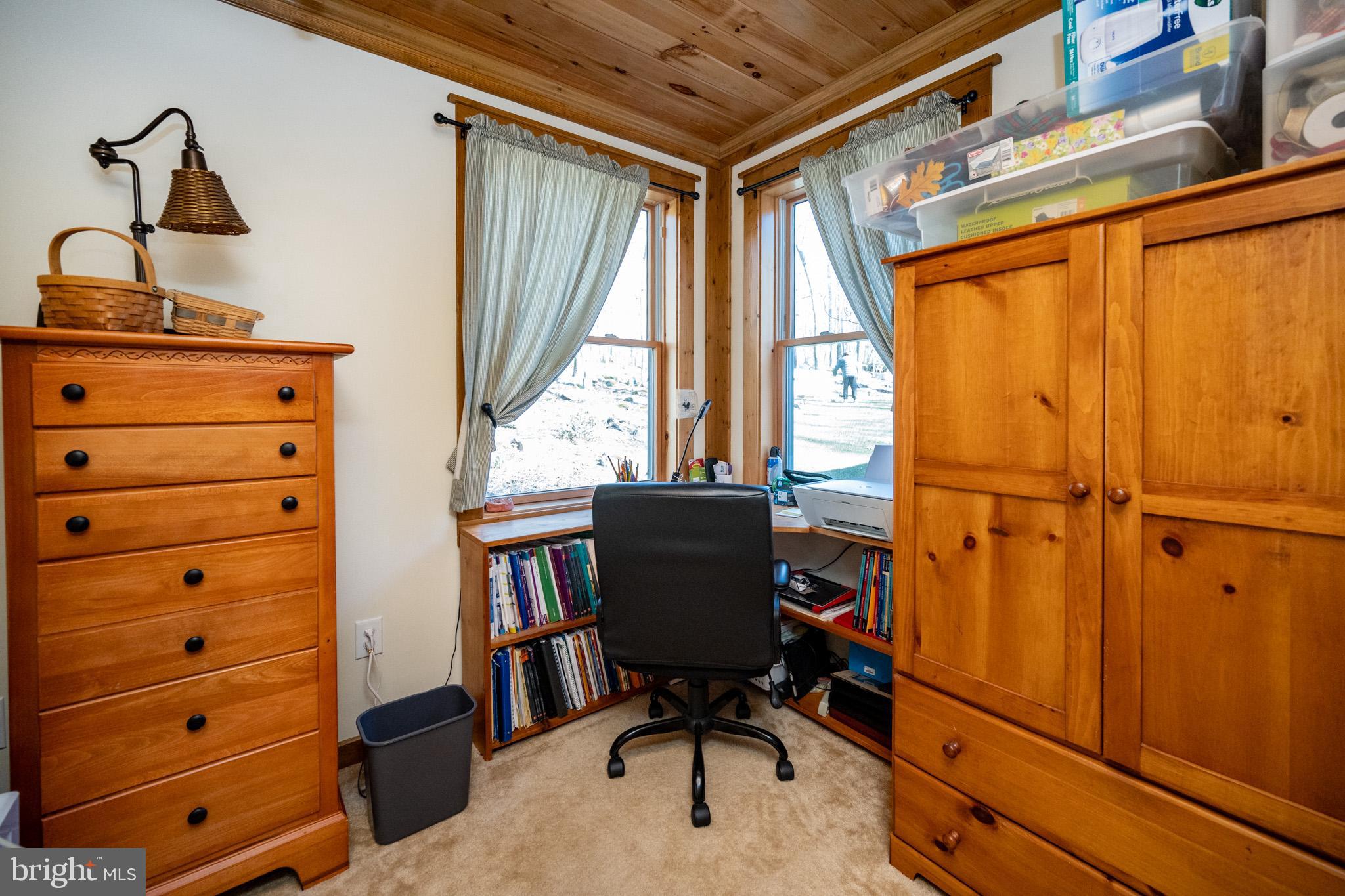 328 Stool Rock Road Oakland, MD 21550 - Photo 40 of 133 a view of a workspace with furniture and a window
