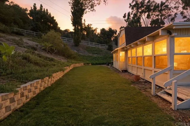 a living room with large window and furniture