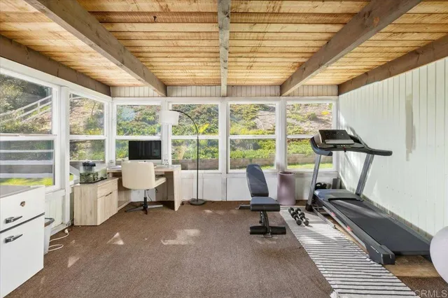 a view of a room that has a bed and a window