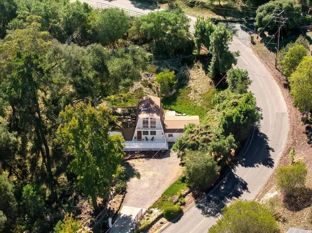 a view of a tree in front of a house