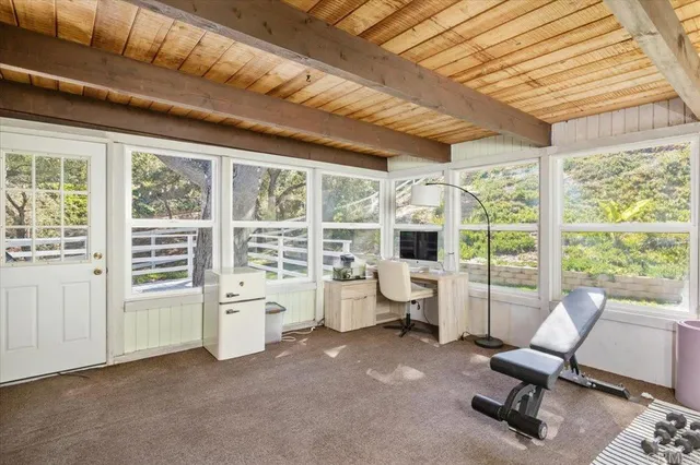 a view of a livingroom with furniture and floor to ceiling window