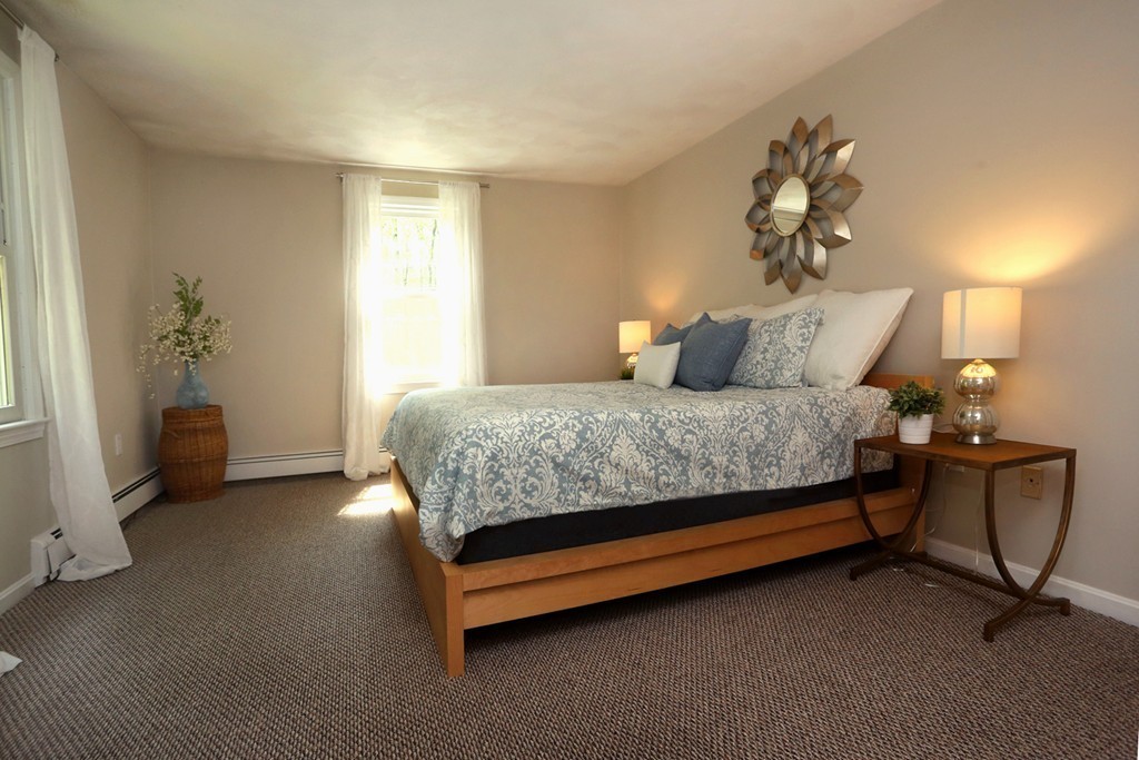 56 Rowley Road Boxford, MA 01921 - Photo 17 of 30 a bedroom with a bed and chair