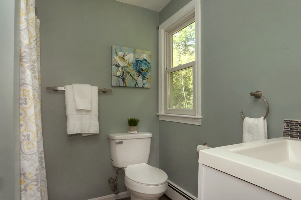 56 Rowley Road Boxford, MA 01921 - Photo 18 of 30 a white toilet sitting next to a bathroom sink