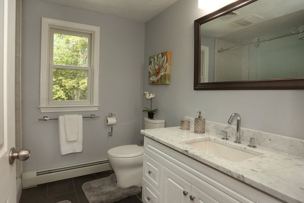 56 Rowley Road Boxford, MA 01921 - Photo 23 of 30 a bathroom with a granite countertop toilet sink and mirror