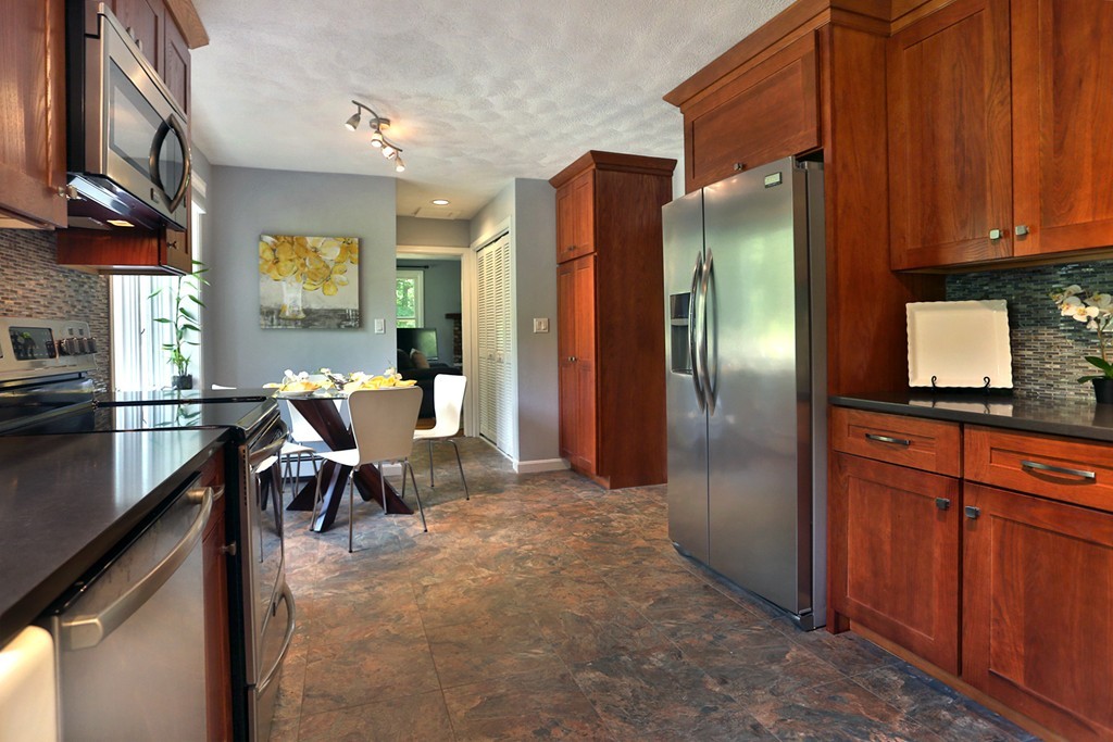 56 Rowley Road Boxford, MA 01921 - Photo 4 of 30 a kitchen with stainless steel appliances granite countertop a refrigerator and a stove top oven