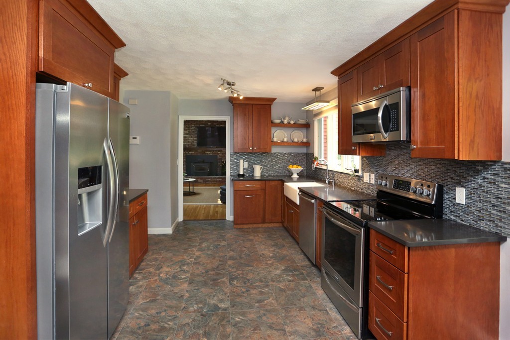56 Rowley Road Boxford, MA 01921 - Photo 6 of 30 a kitchen with stainless steel appliances granite countertop a refrigerator a stove top oven a sink and dishwasher