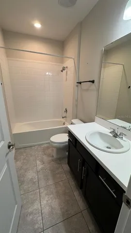 a bathroom with a double vanity sink a toilet and a mirror