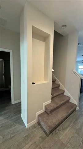 a view of entryway and hall with wooden floor