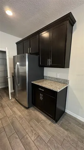 a kitchen with stainless steel appliances granite countertop a refrigerator and a microwave