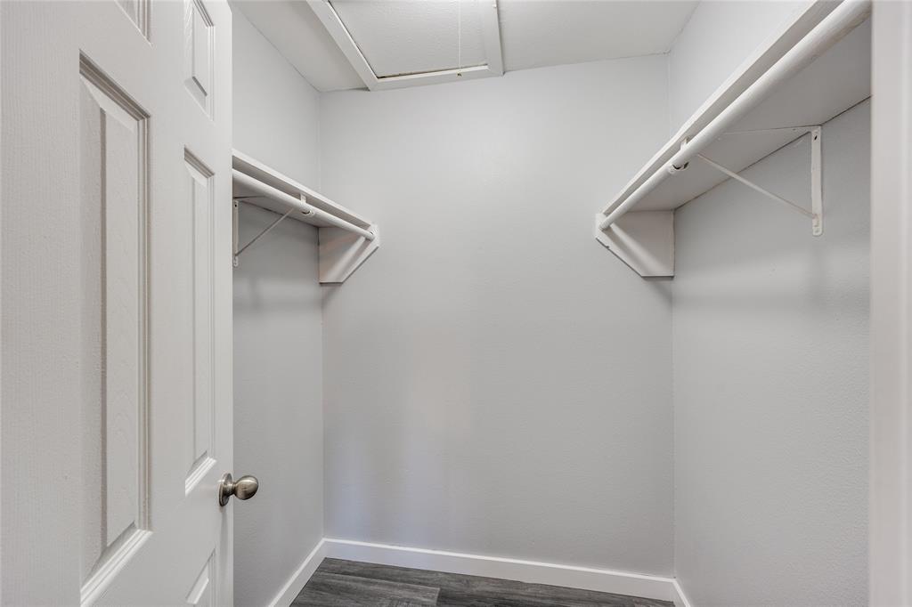 5725 Harvest Hill Road, Unit 2041 Dallas, TX 75230 - Photo 11 of 12 Walk in closet with dark wood-type flooring