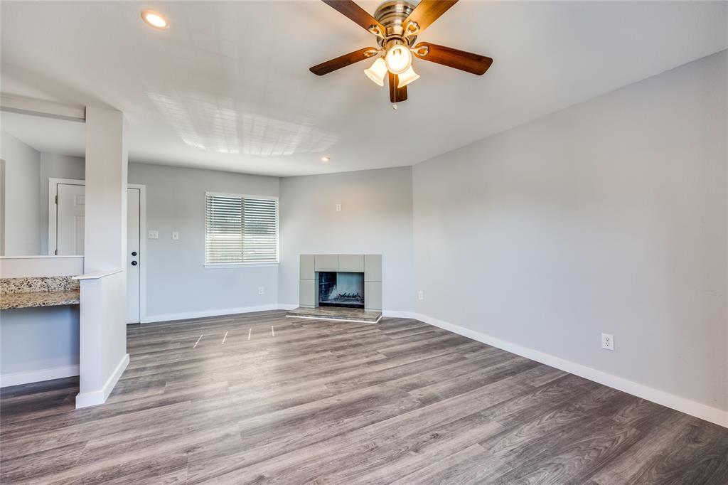 5725 Harvest Hill Road, Unit 2041 Dallas, TX 75230 - Photo 3 of 12 Unfurnished living room featuring wood finished floors, recessed lighting, a fireplace, and a ceiling fan