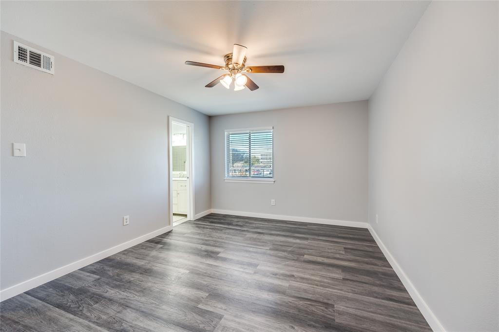 5725 Harvest Hill Road, Unit 2041 Dallas, TX 75230 - Photo 9 of 12 Empty room featuring dark wood-type flooring and a ceiling fan