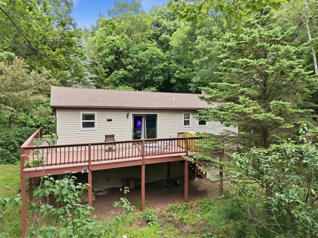 520 Highland Hill Road Jim Thorpe, PA 18235 - Photo 60 of 83 A spacious wooden deck provides an outdoor retreat amidst a lush, private tree-lined setting.