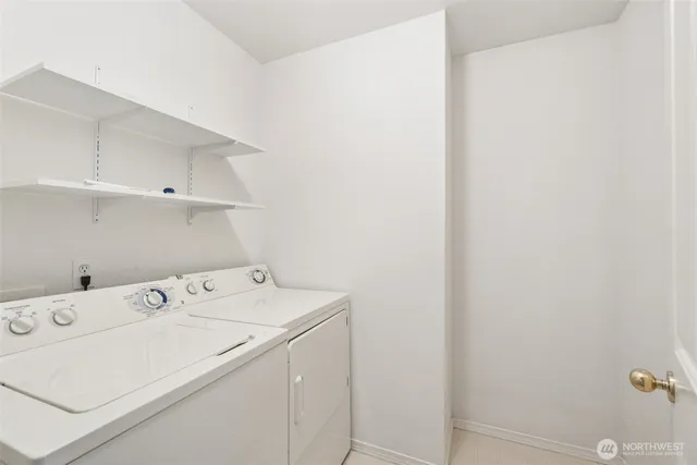 a view of a white house with a yard and garage