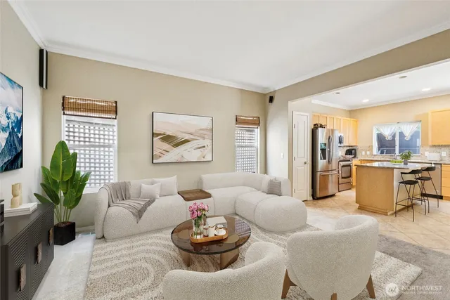 a living room with furniture kitchen and a table