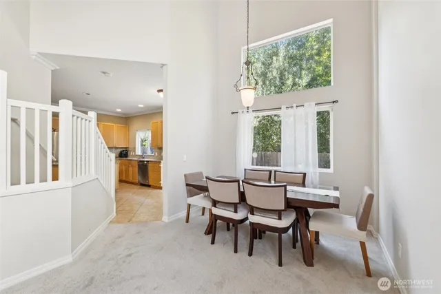 a view of a dining room with furniture and a window