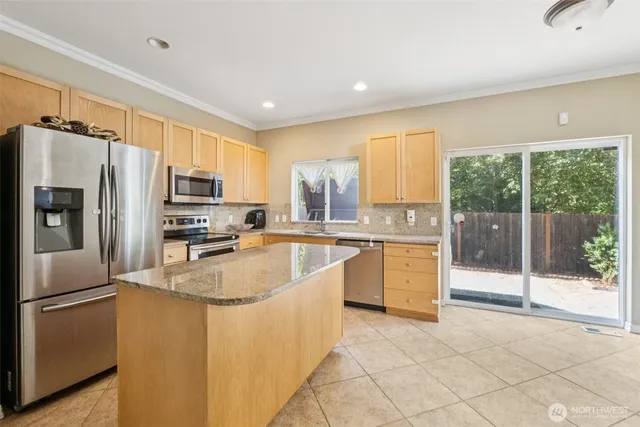 a view of a kitchen with a sink refrigerator and window
