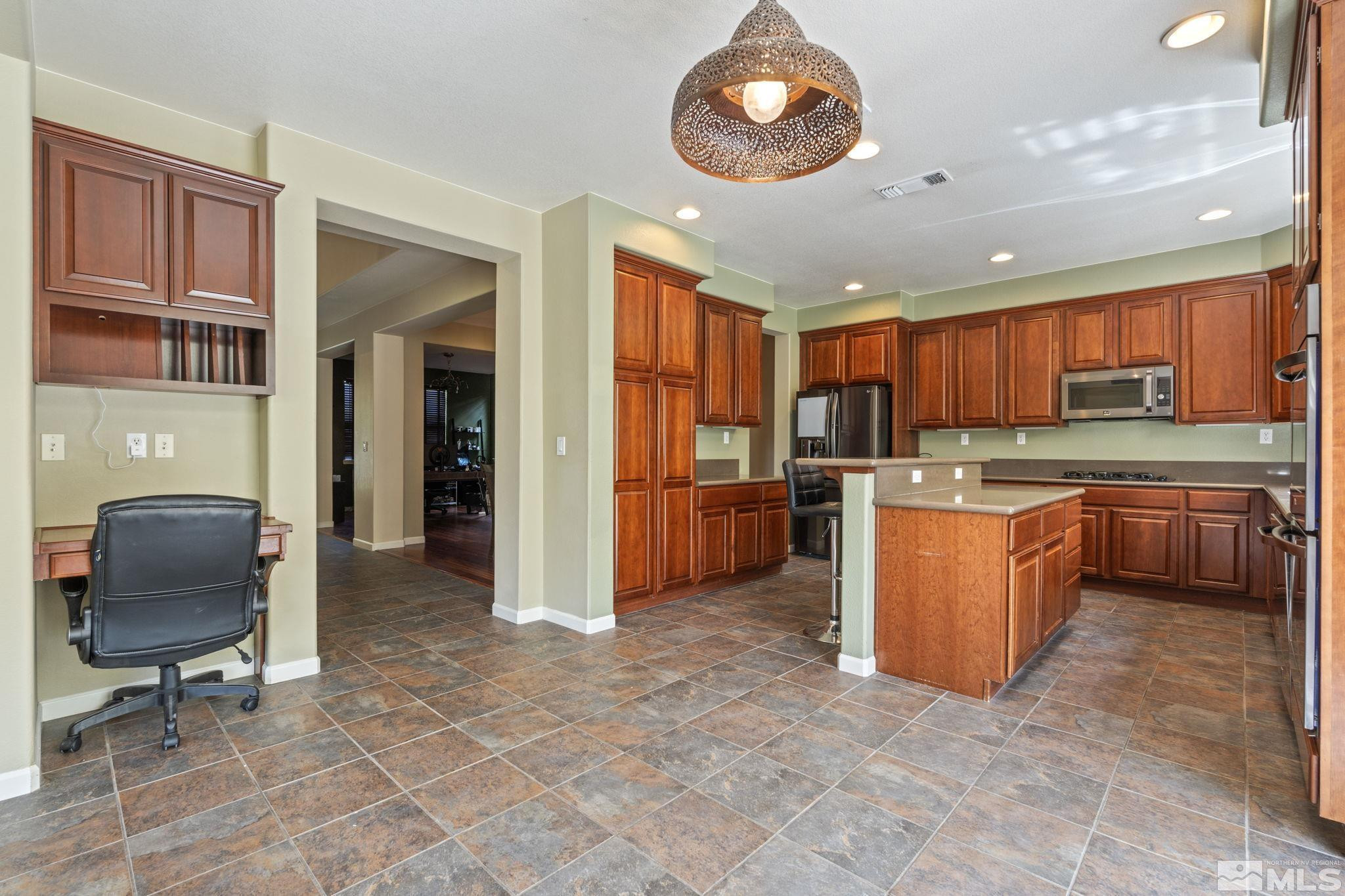 10890 Sand Hollow Court Reno, NV 89521 - Photo 11 of 40 a kitchen with stainless steel appliances granite countertop a stove top oven a sink a counter top space and cabinets