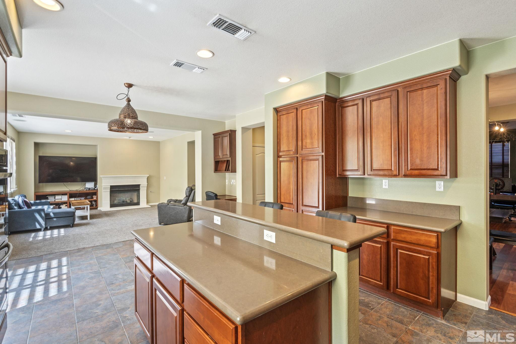 10890 Sand Hollow Court Reno, NV 89521 - Photo 16 of 40 a kitchen with a stove a sink and a refrigerator