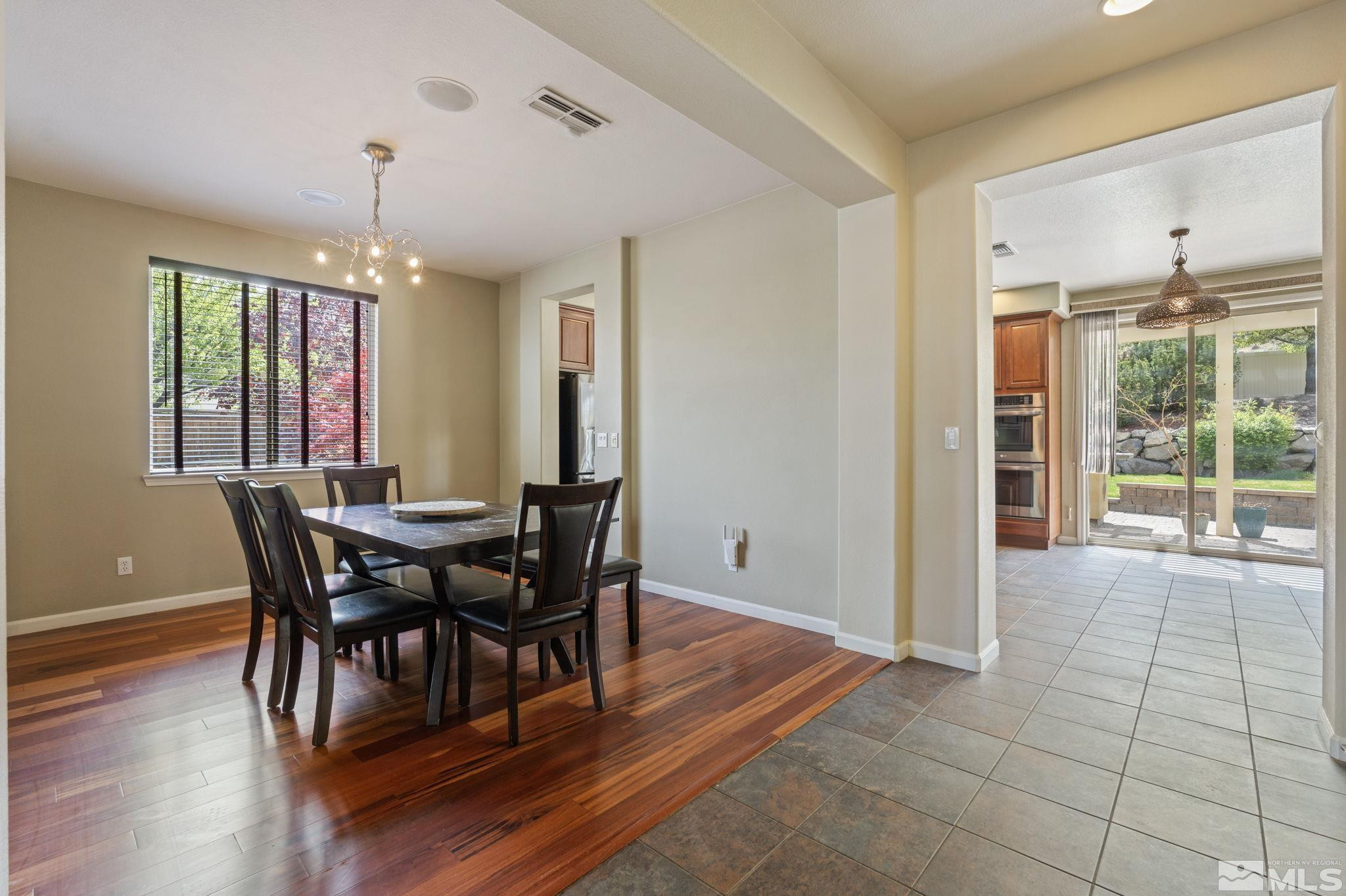 10890 Sand Hollow Court Reno, NV 89521 - Photo 17 of 40 a view of a dining room with furniture window and wooden floor