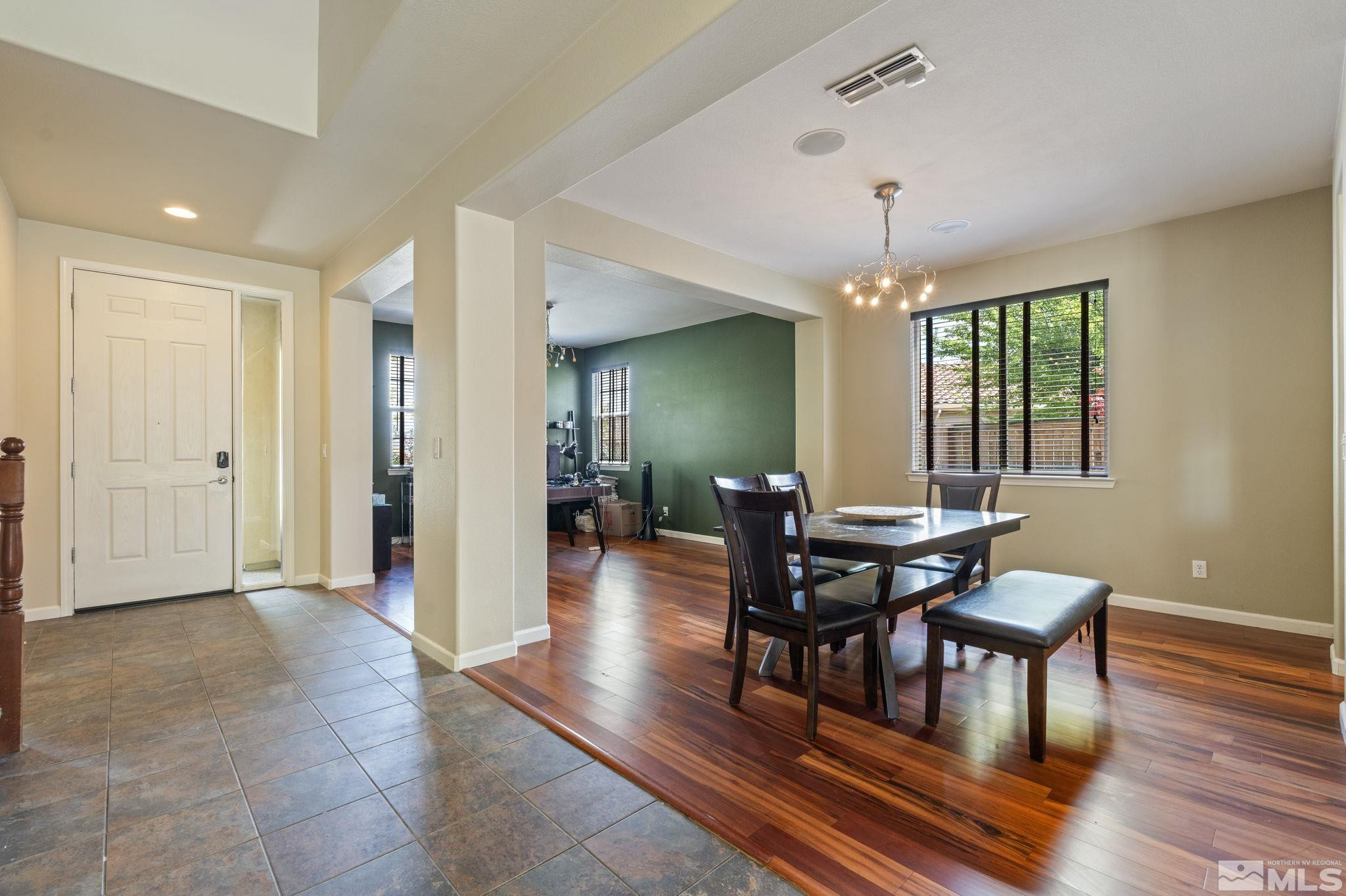 10890 Sand Hollow Court Reno, NV 89521 - Photo 19 of 40 a view of a dining room with furniture window and wooden floor