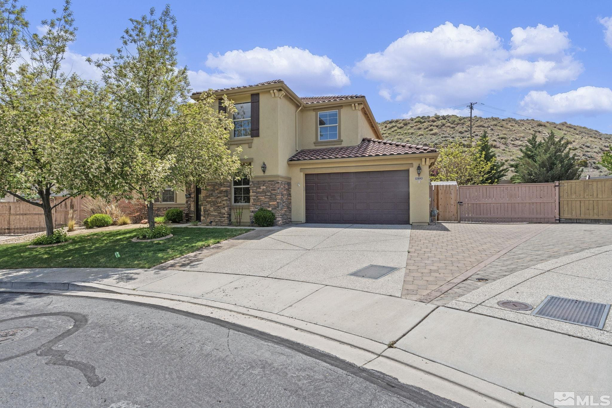 10890 Sand Hollow Court Reno, NV 89521 - Photo 2 of 40 a front view of a house with a yard and trees