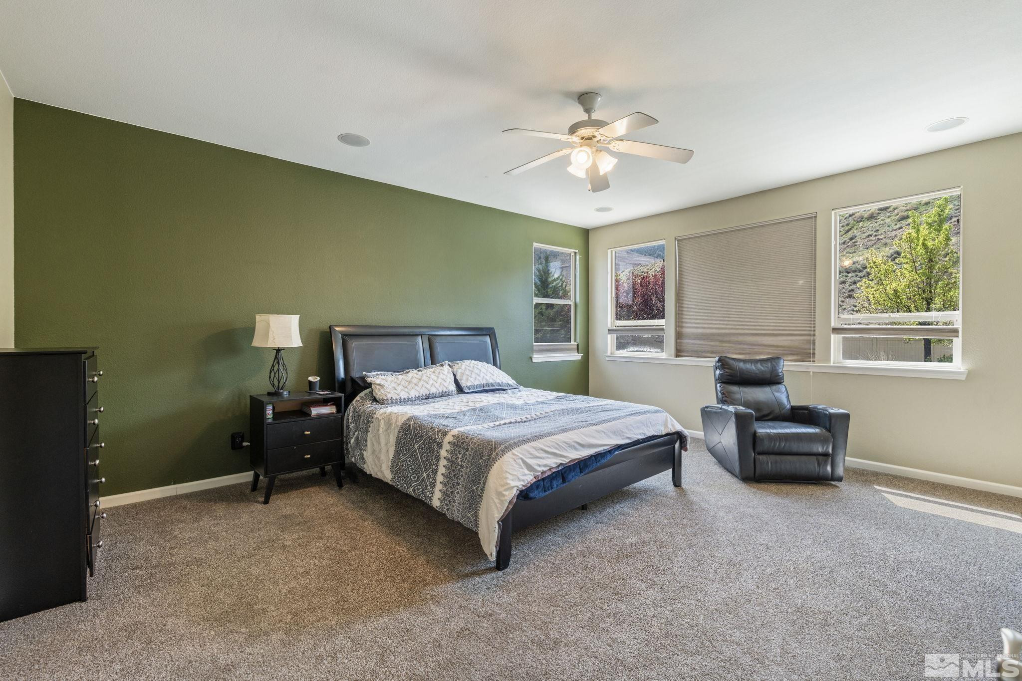 10890 Sand Hollow Court Reno, NV 89521 - Photo 23 of 40 a bedroom with a bed and a chandelier