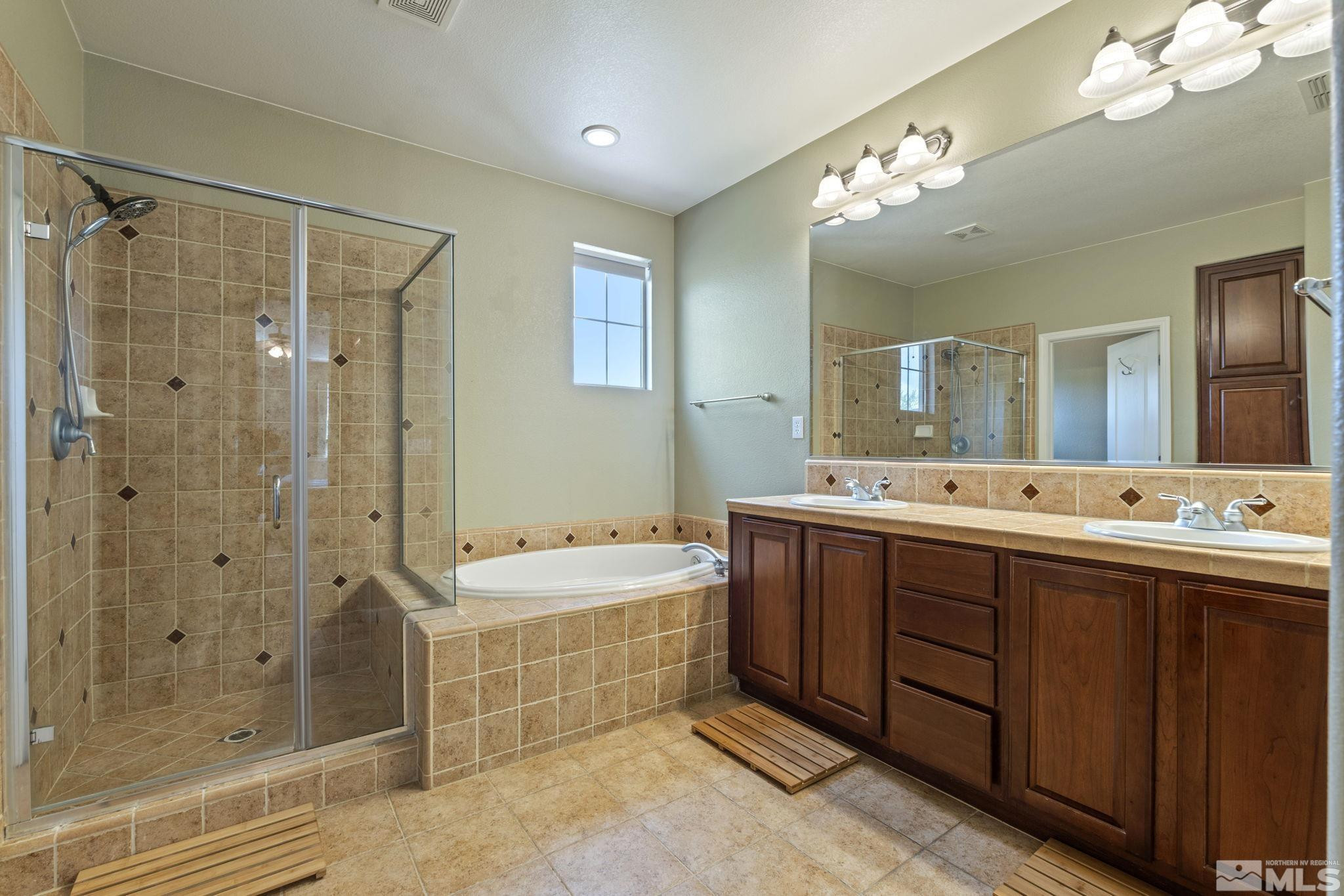 10890 Sand Hollow Court Reno, NV 89521 - Photo 24 of 40 a spacious bathroom with a double vanity sink mirror and shower