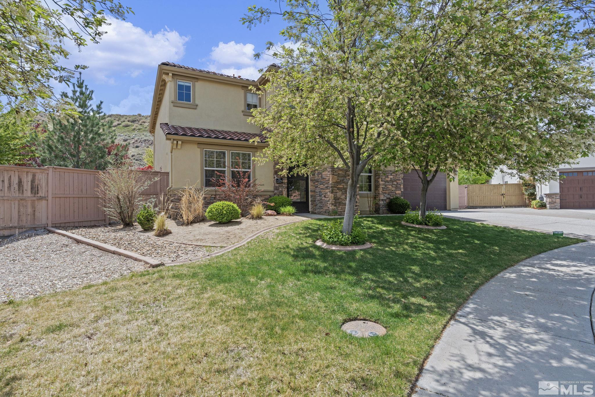 10890 Sand Hollow Court Reno, NV 89521 - Photo 3 of 40 a view of a house with backyard and trees