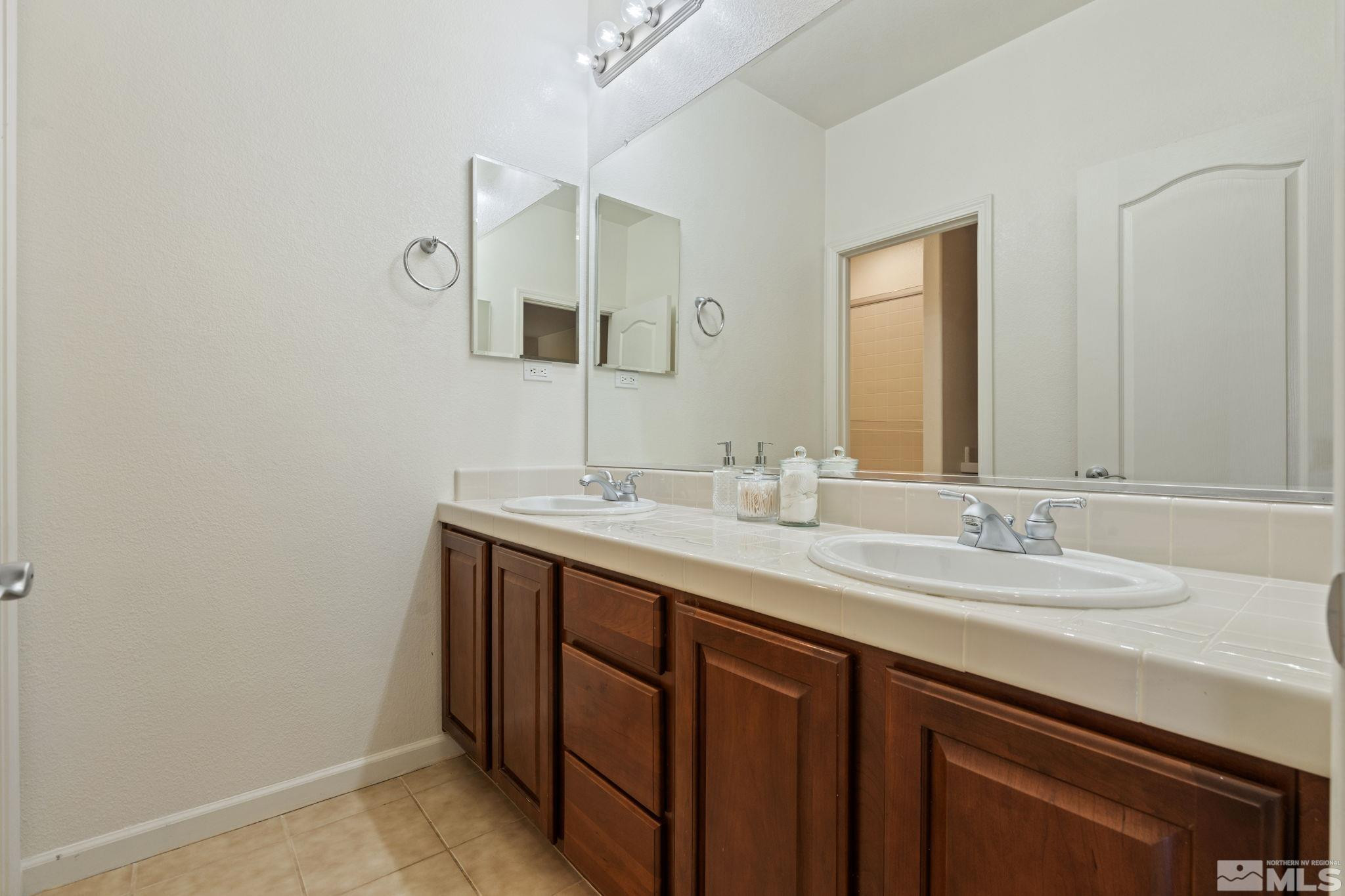 10890 Sand Hollow Court Reno, NV 89521 - Photo 31 of 40 a bathroom with a sink and a mirror