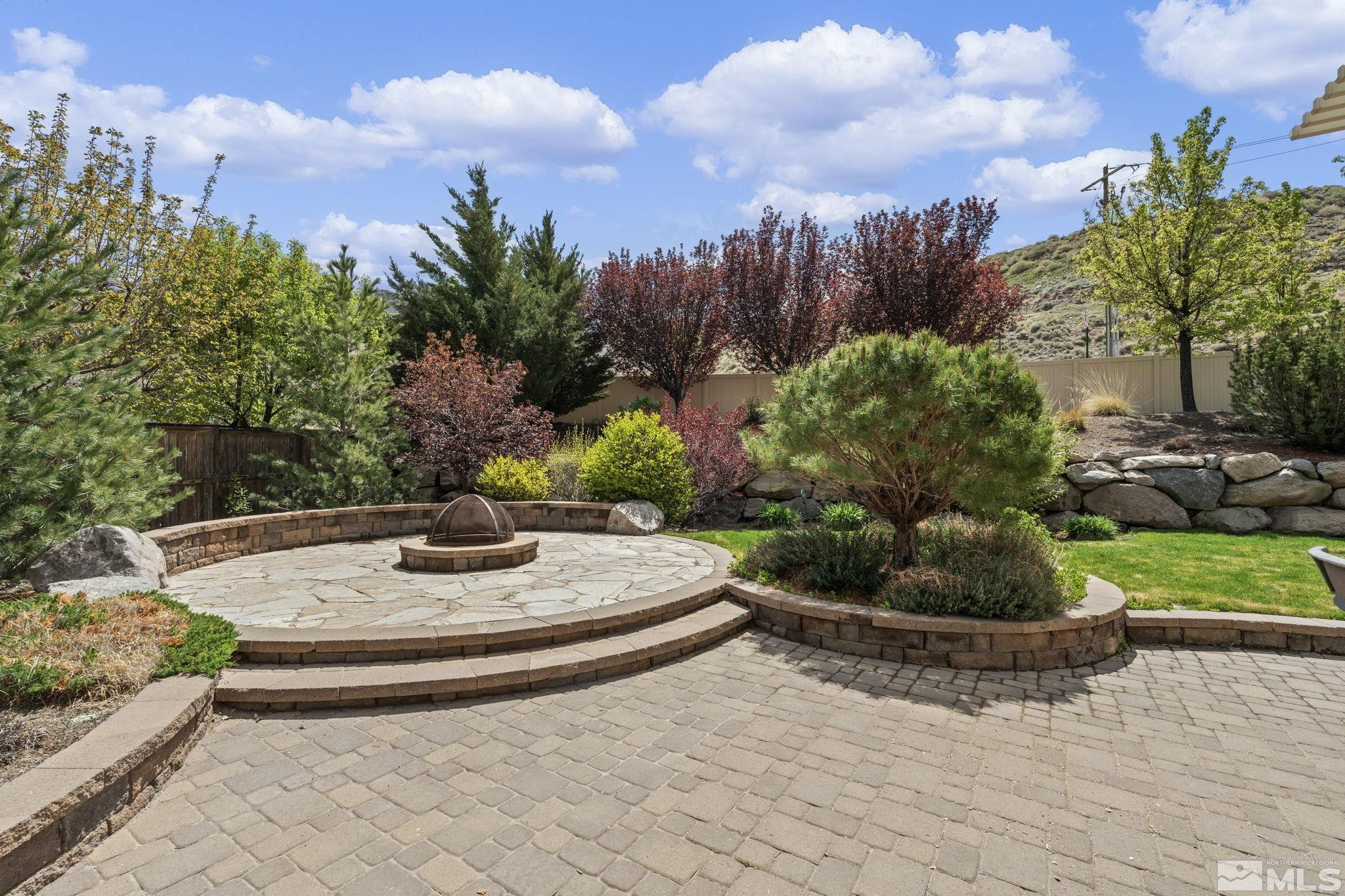 10890 Sand Hollow Court Reno, NV 89521 - Photo 36 of 40 a view of a backyard with plants and a fountain