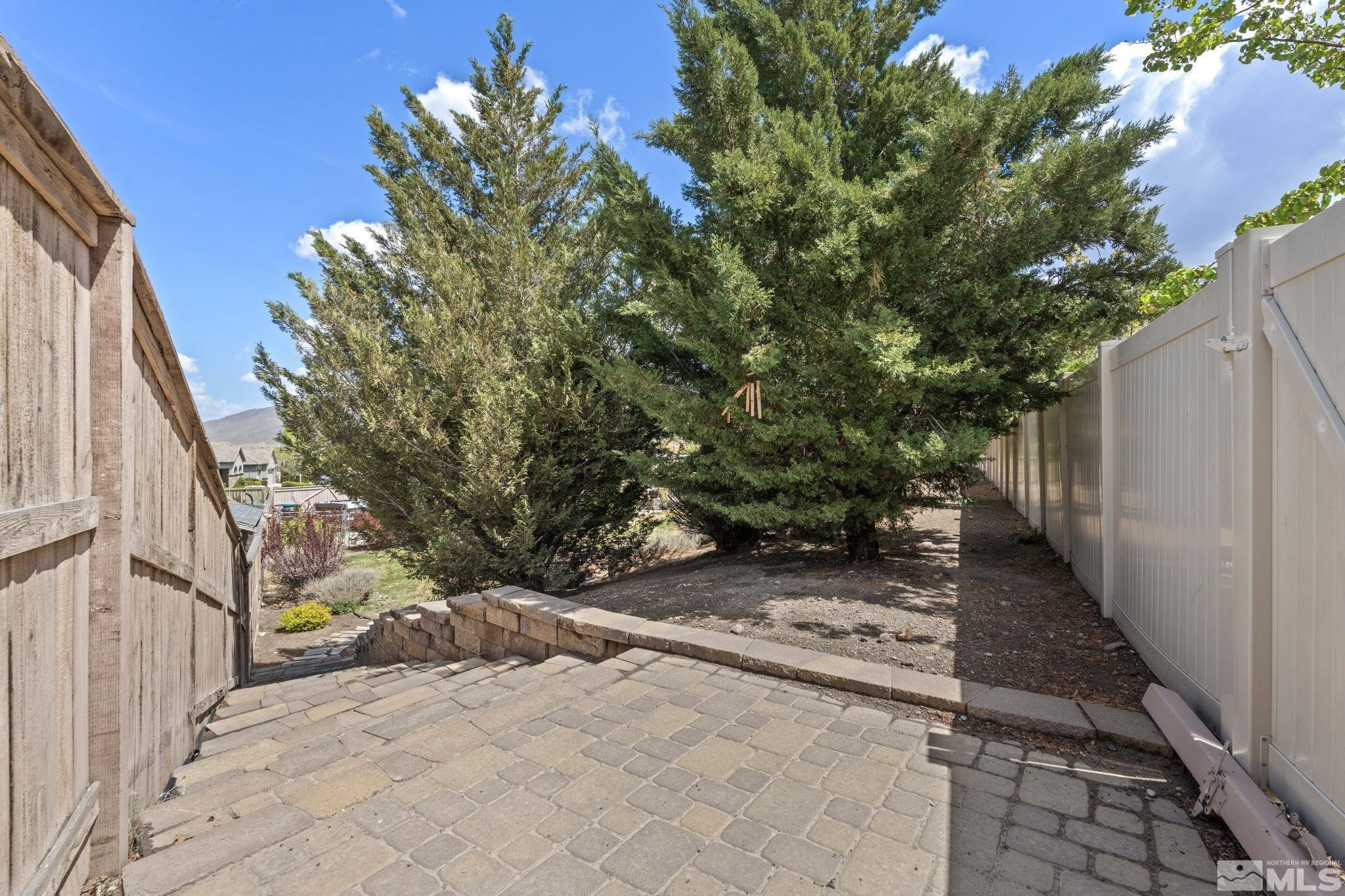 10890 Sand Hollow Court Reno, NV 89521 - Photo 40 of 40 a view of a backyard with potted plants and wooden fence
