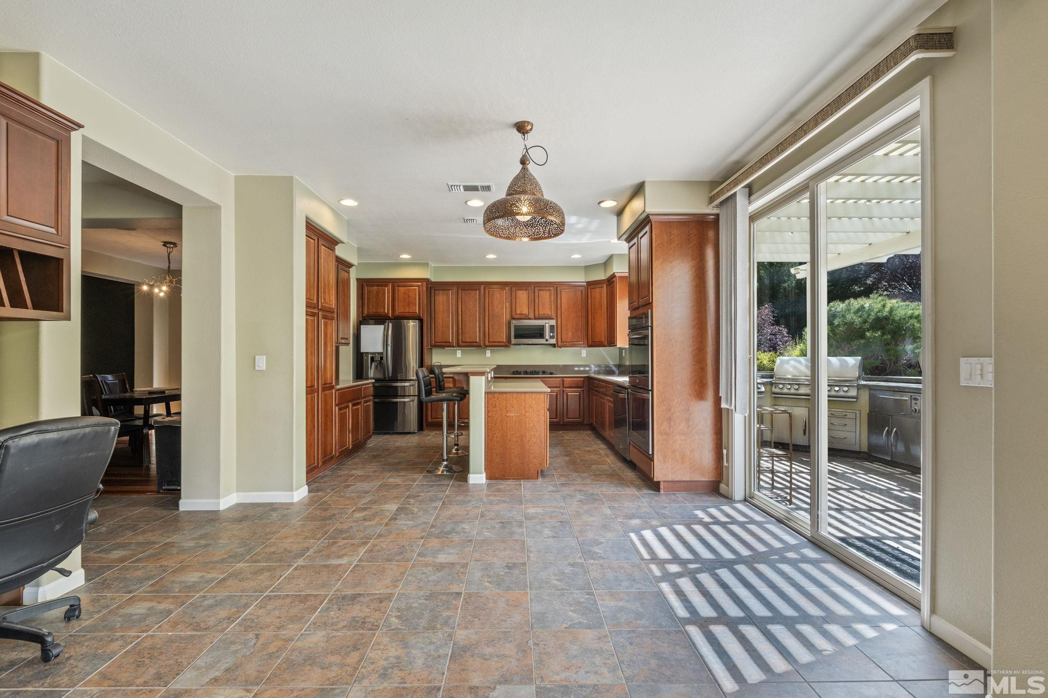 10890 Sand Hollow Court Reno, NV 89521 - Photo 9 of 40 a dining hall with stainless steel appliances granite countertop a refrigerator and a sink