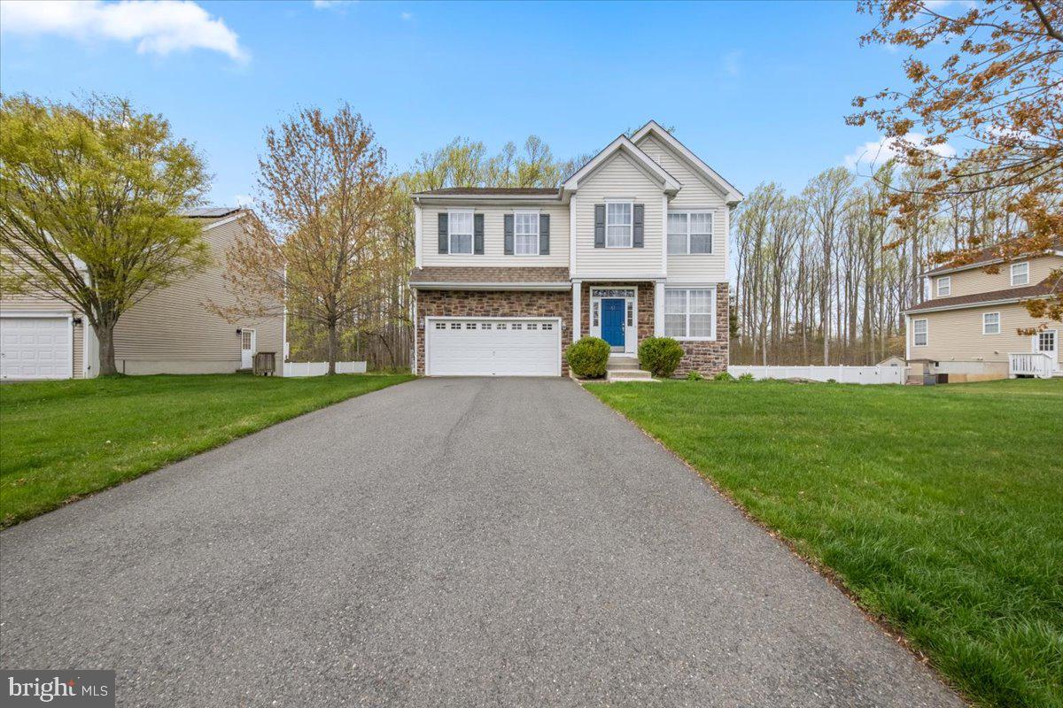 61 Homestead Drive Pemberton, NJ 08068 - Photo 1 of 40 a front view of a house with a yard and palm trees