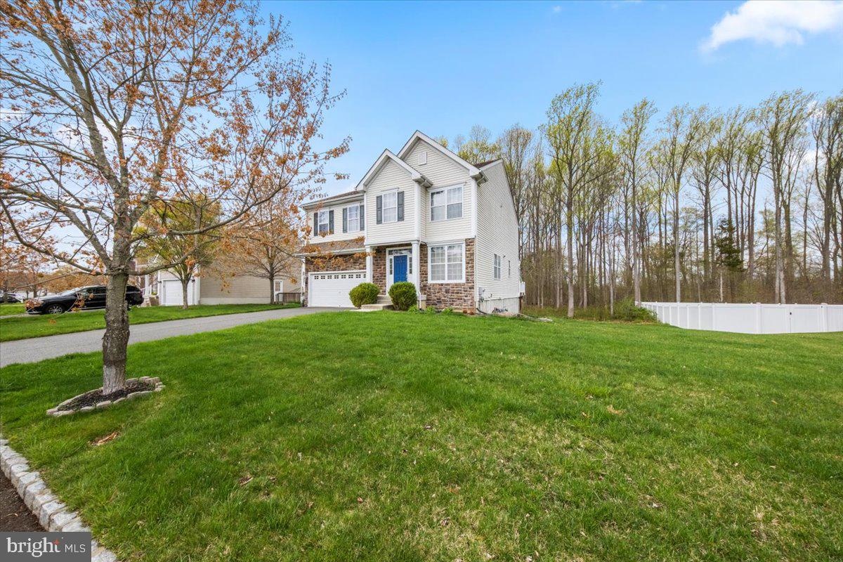 61 Homestead Drive Pemberton, NJ 08068 - Photo 2 of 40 a front view of a house with a yard and trees