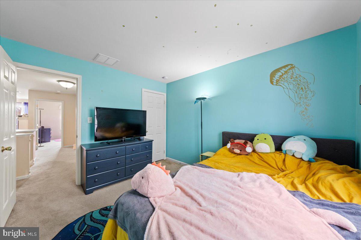 61 Homestead Drive Pemberton, NJ 08068 - Photo 21 of 40 a bedroom with a bed and a flat screen tv