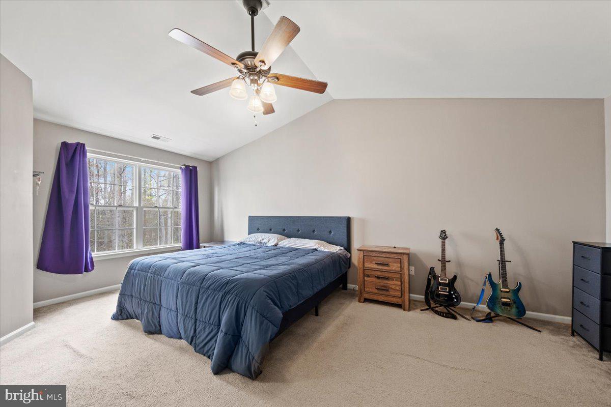 61 Homestead Drive Pemberton, NJ 08068 - Photo 22 of 40 a bedroom with a bed and a chandelier