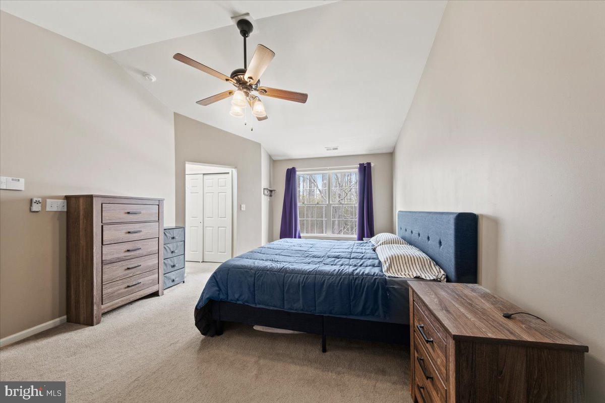 61 Homestead Drive Pemberton, NJ 08068 - Photo 23 of 40 a bedroom with a bed and a chandelier