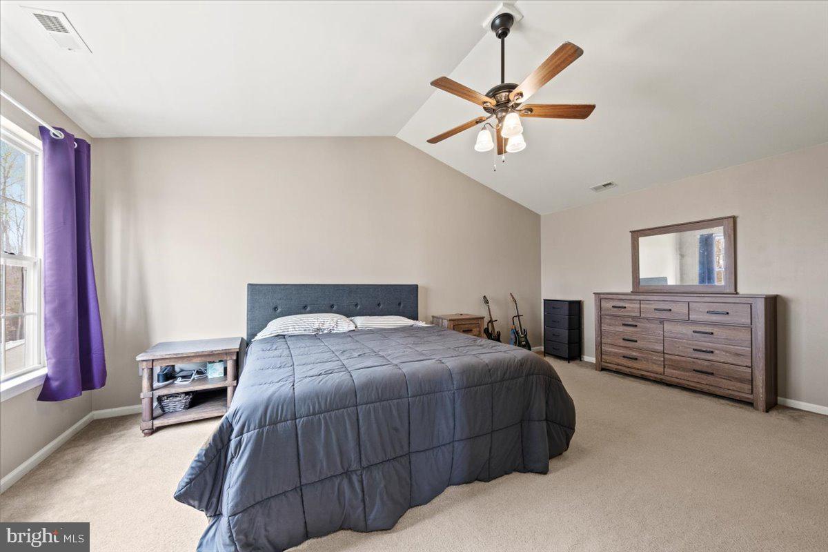 61 Homestead Drive Pemberton, NJ 08068 - Photo 24 of 40 a bedroom with a bed a dresser and a chandelier