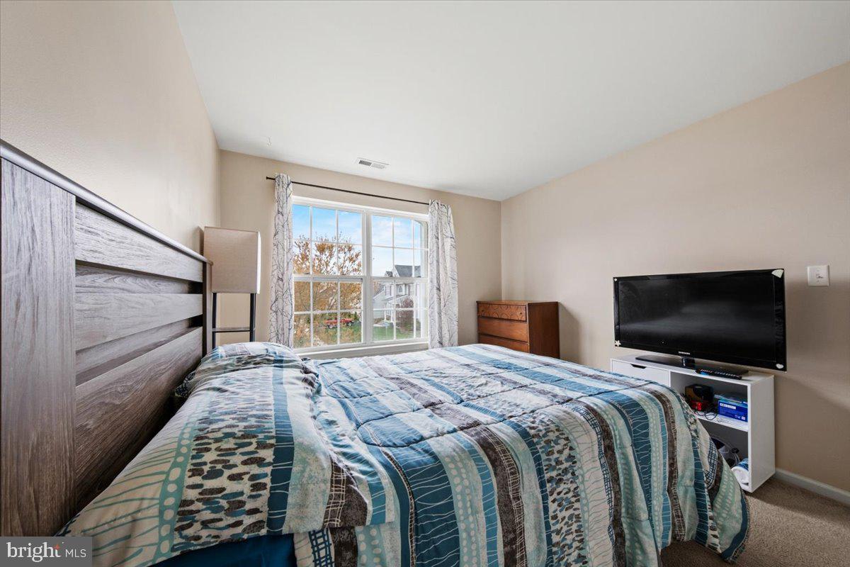 61 Homestead Drive Pemberton, NJ 08068 - Photo 26 of 40 a bedroom with a bed and a flat screen tv