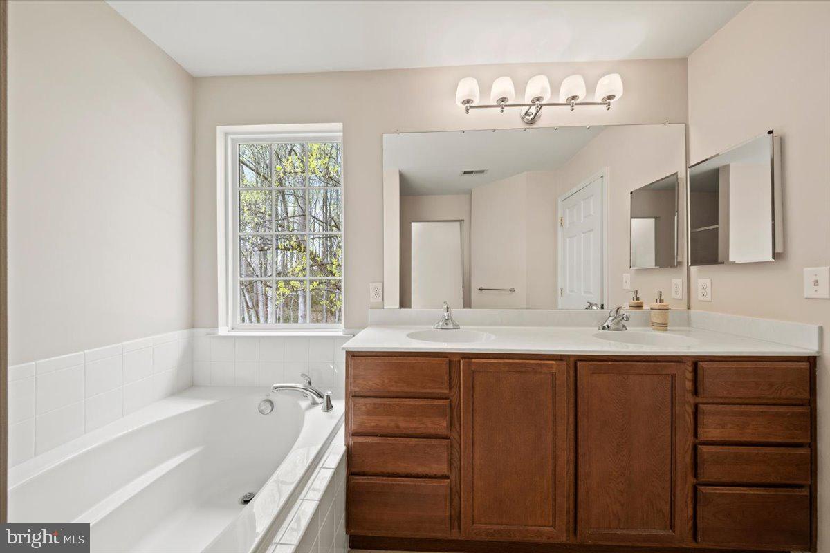 61 Homestead Drive Pemberton, NJ 08068 - Photo 29 of 40 a bathroom with a tub sink and mirror