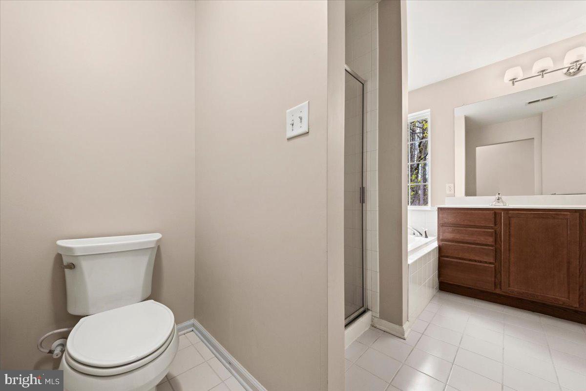 61 Homestead Drive Pemberton, NJ 08068 - Photo 31 of 40 a white toilet sitting in a bathroom next to a sink