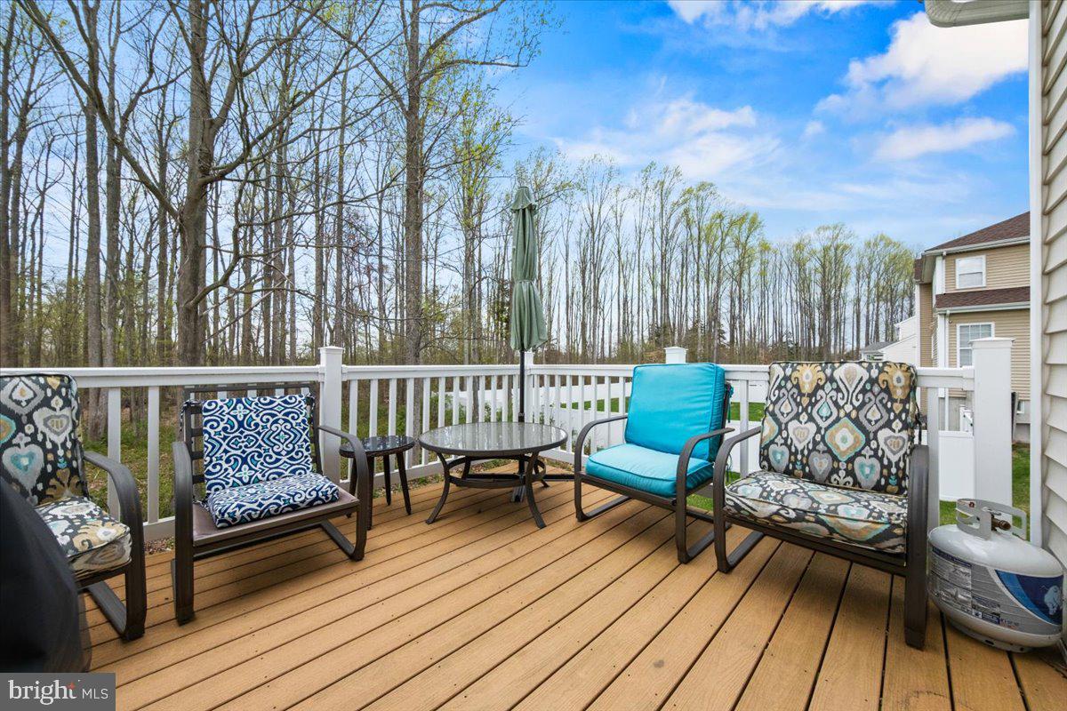 61 Homestead Drive Pemberton, NJ 08068 - Photo 37 of 40 a balcony with wooden floor table and chairs
