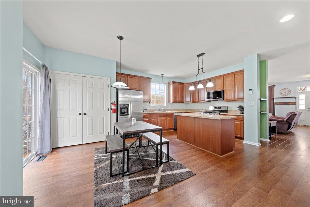 61 Homestead Drive Pemberton, NJ 08068 - Photo 4 of 40 a kitchen with stainless steel appliances kitchen island granite countertop a refrigerator a stove a sink dishwasher and white cabinets with wooden floor