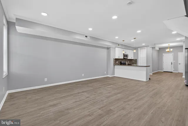a view of kitchen with refrigerator and microwave