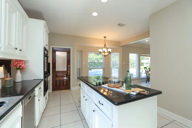 a kitchen with stainless steel appliances granite countertop a sink and a stove